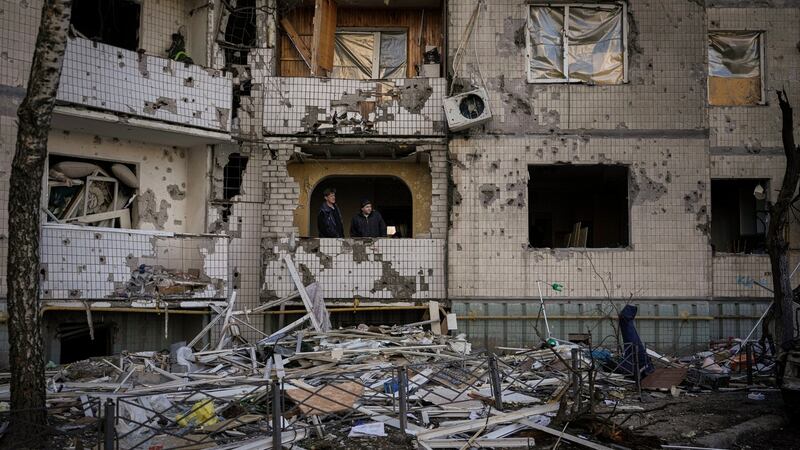 Residents attempt repairs on the shattered windows of an apartment block damaged by a bombing the previous day in Kyiv on Monday. Photograph: Vadim Ghirda/AP