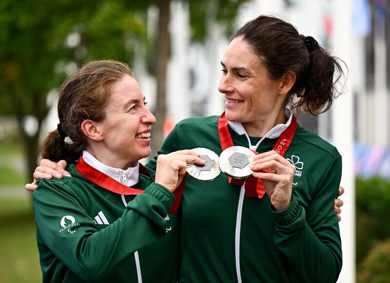 Linda Kelly and Katie-George Dunlevy celebrate with their silver medals after the women's B road race at the 2024 Paralympic Games. Photograph: Harry Murphy/Sportsfile