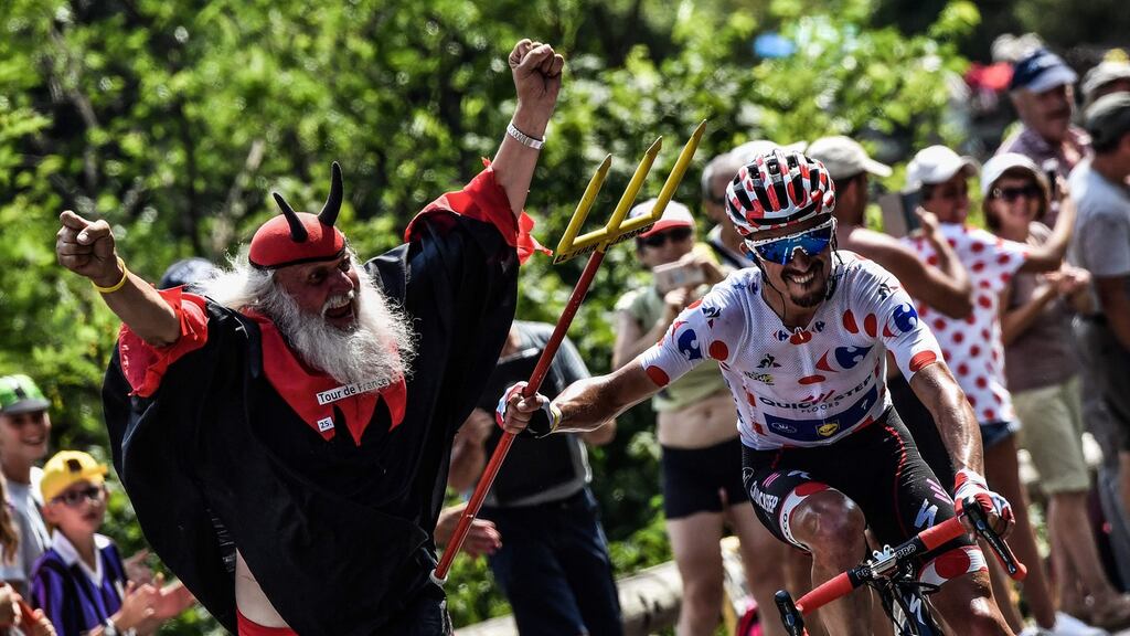 In this file photograph taken in 2018, France’s Julian Alaphilippe, wearing the best climber’s polka dot jersey, seizes the fork of Tour de France fan Didi Senft during the 17th stage of the Tour de France. Photograph: Jeff Pachoud/AFP via Getty Images