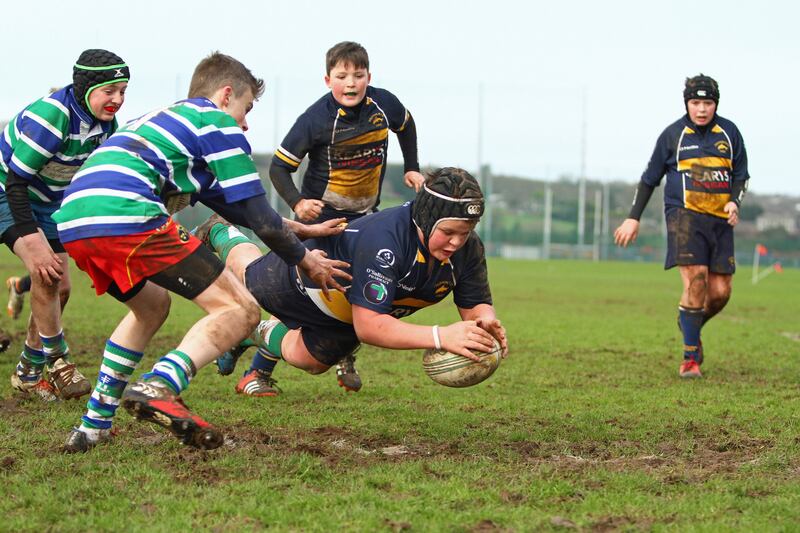 Mud larks: Greg Forrest about to touch down for Dolphin against Kinsale. Photograph: Declan Forrest