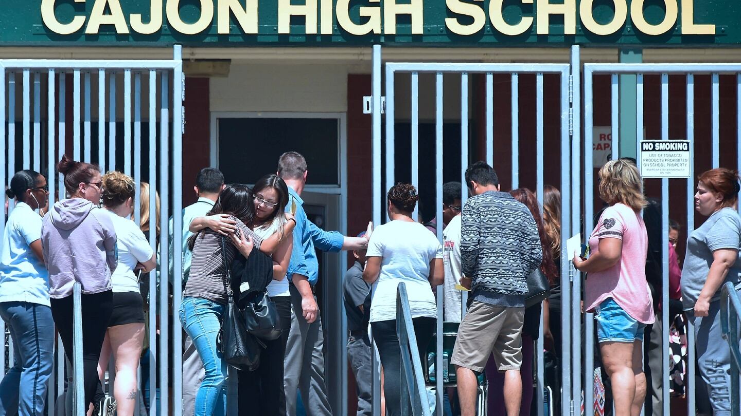 A student and her mother embrace upon leaving Cajon High School in San Bernardino, California, where children from nearby North Park Elementary School had been brought after a shooting. Photograph: Frederic J Brown/AFP/Getty Images