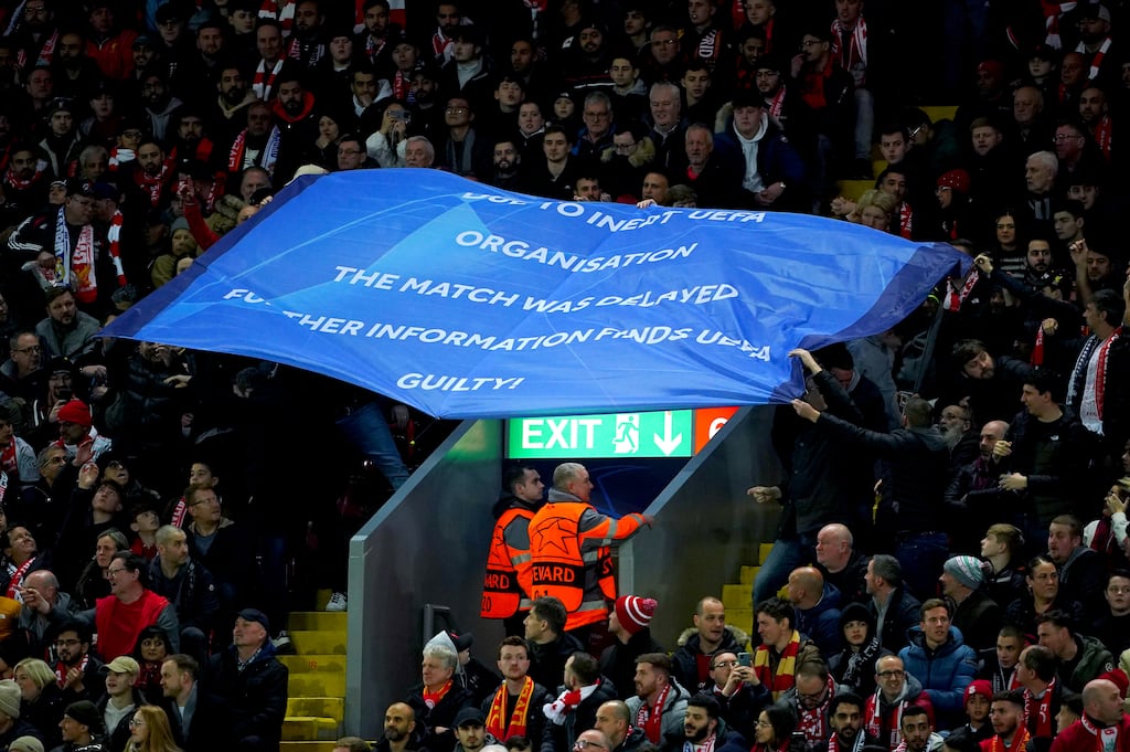 Liverpool fans hold up a banner criticising Uefa during the Champions League round of 16 match at Anfield, Liverpool on Tuesday. Photograph: PA