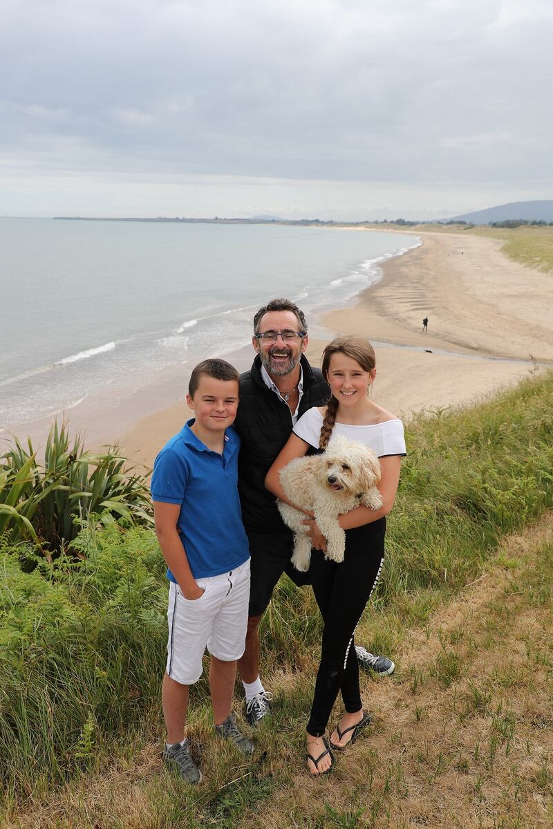 Benji Bennett (centre) with two of his three children Robbie (13) and Molly (12), with family pet Bailey at Potter's Point, Brittas Bay, Co Wicklow. Photograph: Nick Bradshaw/The Irish Times