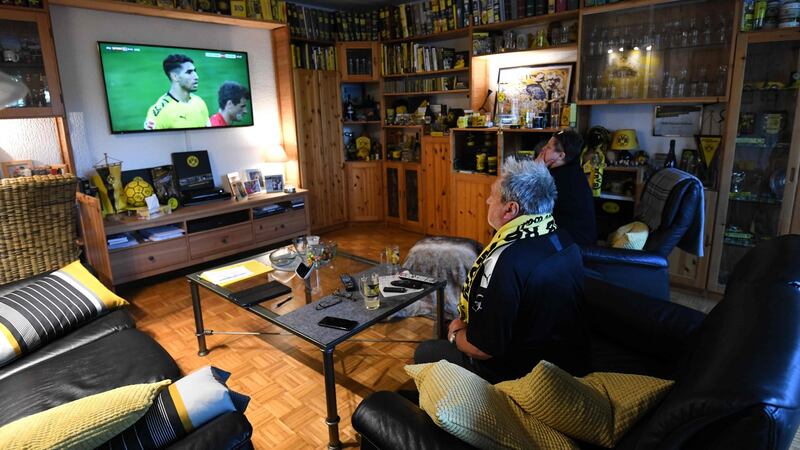 Borussua Dortmund fans watch Der Klassiker on the telly. Photograph: Ina Fassbender/Getty/AFP