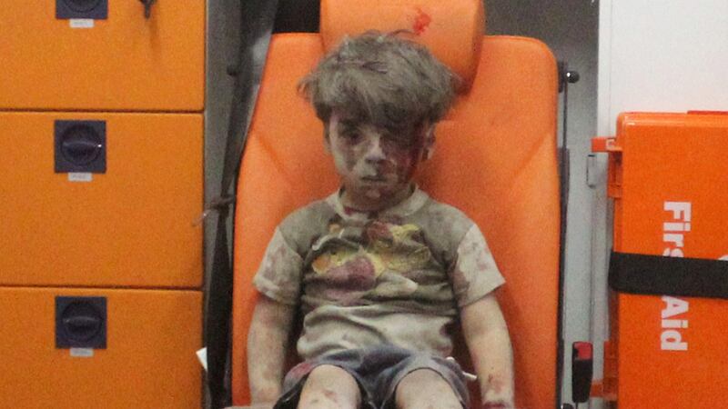 Omran Daqneesh (5) sits inside an ambulance after being rescued following an air strike in the rebel-held al-Qaterji neighbourhood of Aleppo, Syria, in August. Photograph: Mahmoud Rslan/Reuters
