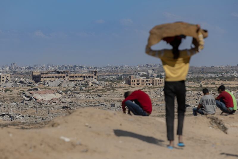 A girl carries a bowl of bread on her head back to her family in Nuseirat, in the Gaza Strip, on Tuesday. Photograph: Saher Alghorra/The New York Times