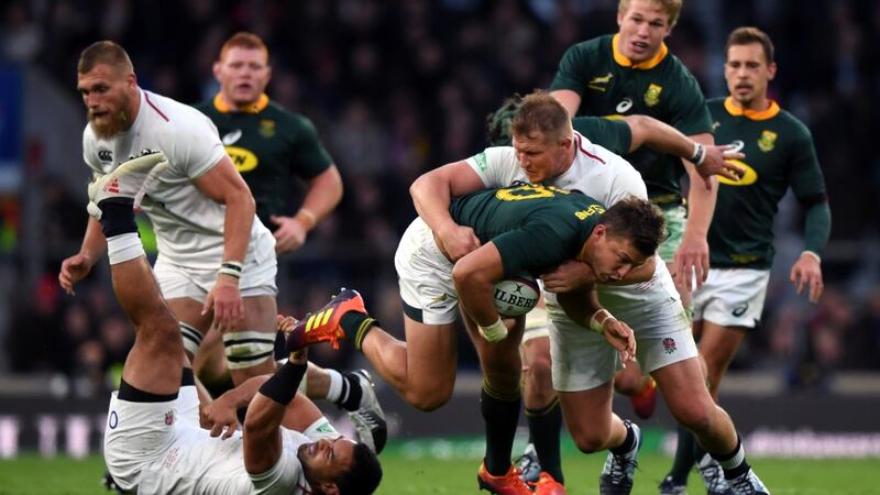 Handre Pollard of South Africa is tackled by Dylan Hartley of England. Photograph: Shaun Botterill/Getty Images