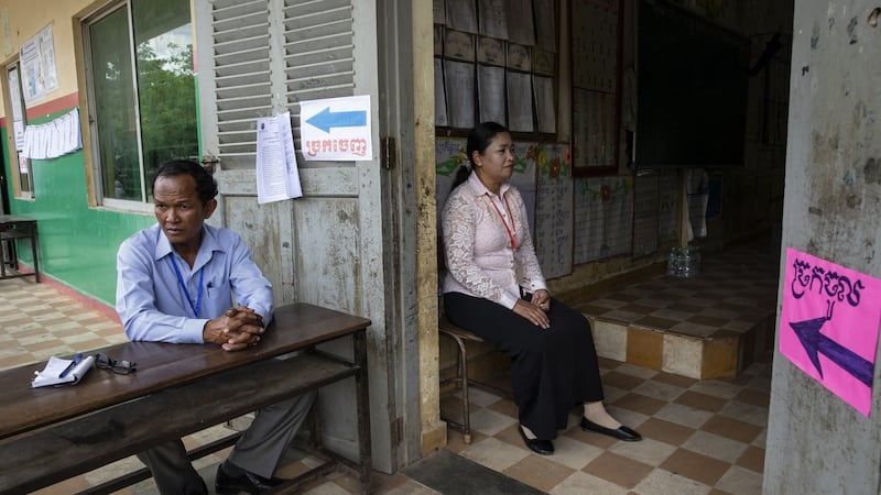 Cambodian election workers wait for voters during an election whose fairness has been criticised by the US and the EU, in Phnom Penh, Cambodia. Photograph: Paula Bronstein/Getty Images