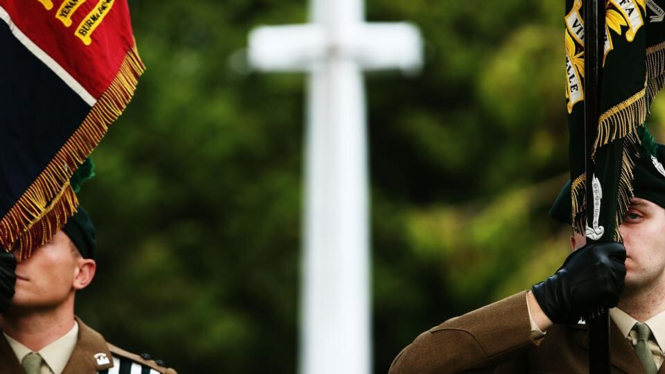 Flag bearers stand to attention at the unveiling of the Cross of Sacrifice at Glasnevin Cemetery in Dublin. Photograph: Brian Lawless/PA Wire
