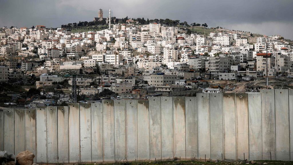 The controversial Israeli separation barrier separating the Palestinian West Bank village of Eizariya (foreground) and Jerusalem (background). Photograph: Thomas Coex/AFP/Getty Images