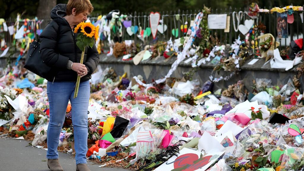 A woman walks past flowers and tributes displayed in memory of the twin mosque massacre victims at the Botanical Garden in Christchurch on March 29th. Photograph: Sanka Vidanagama/AFP