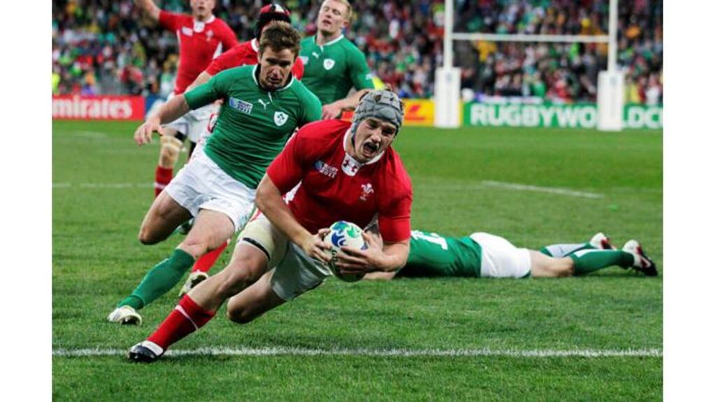 Jonathan Davies delivers the knockout blow as Ireland's World Cup dream is ended by Wales in Wellington. Photograph: Marcos Brindicci/Reuters