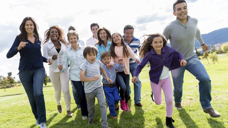 Group of people running outdoors and looking very happy
