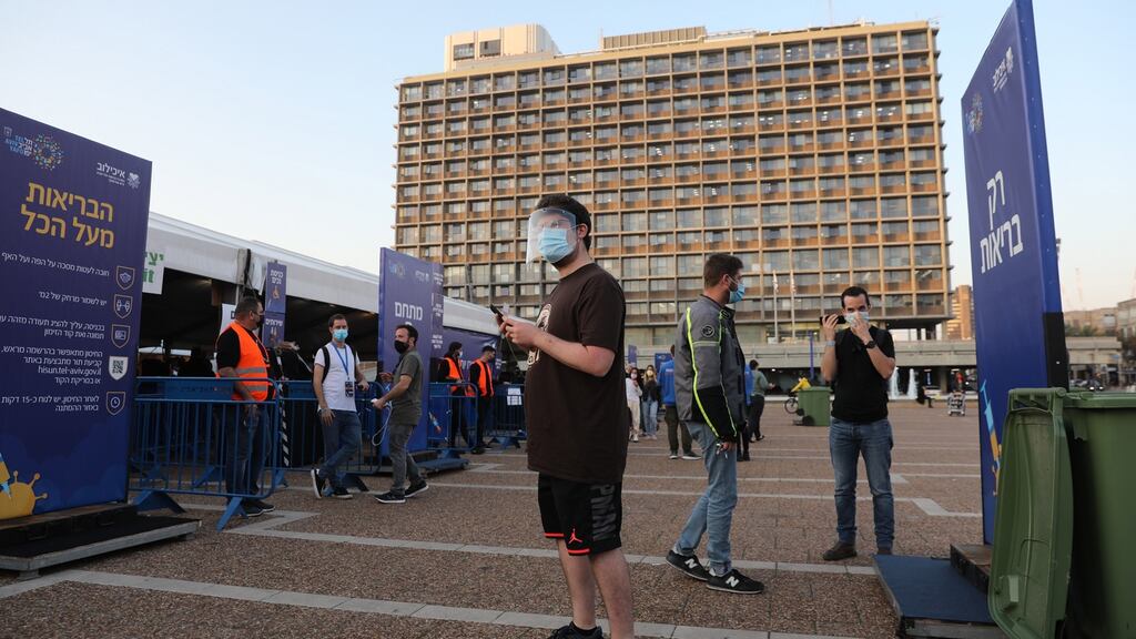A queue to receive the Covid-19 vaccine outside the new Tel Aviv municipality vaccines centre in Rabin square, Tel Aviv. Photograph: Abir Sultan/EPA