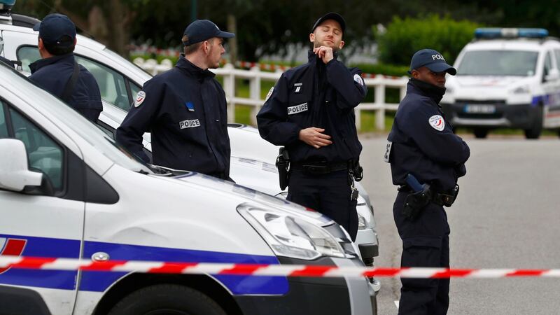 Policemen at a roadblock at the scene where a French police commander was stabbed to death in front of his home in the Paris suburb of Magnanville. Photograph: Christian Hartmann/Reuters.