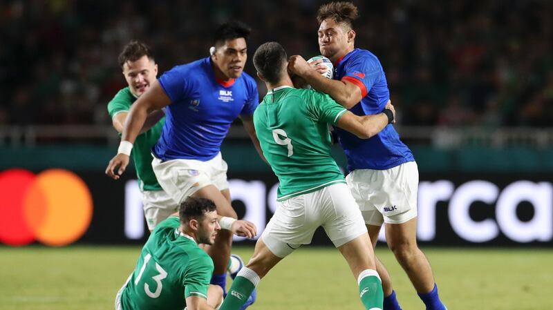 Conor Murray tackles Samoa captain Jack Lam. Photograph: Shaun Botterill/Getty