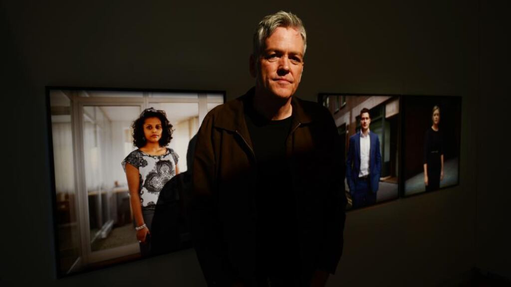 On the market: Mark Curran with three of his portraits of traders at the Gallery of Photography in Dublin. Photograph: Alan Betson/The Irish Times