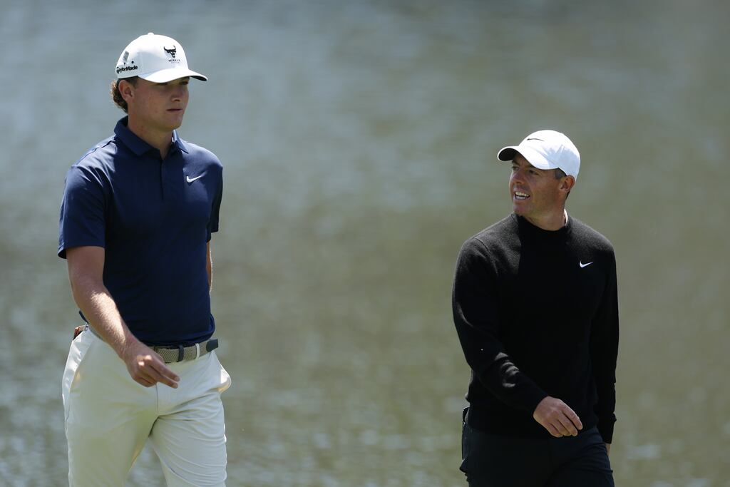 Amateur Noah Kent of the United States and Rory McIlroy of Northern Ireland walk on the 16th hole at Augusta. Photograph: Richard Heathcote/Getty