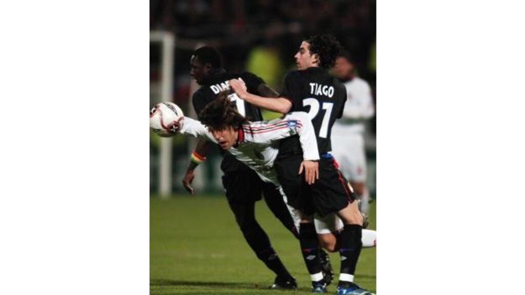 AC Milan's Italian midfielder Andrea Pirlo battles with Lyon midfielders Tiago and Mahamadou Diarra during last night's Champion's League quarter-final in Lyon.