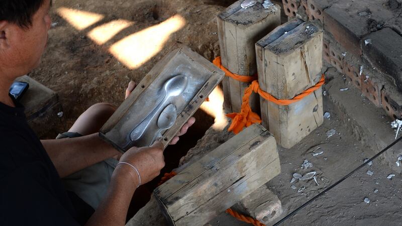 Kien Pheng making spoons from recycled explosives at Ban Napia in Laos. Photograph: Brenda Fitzsimons / The Irish Times
