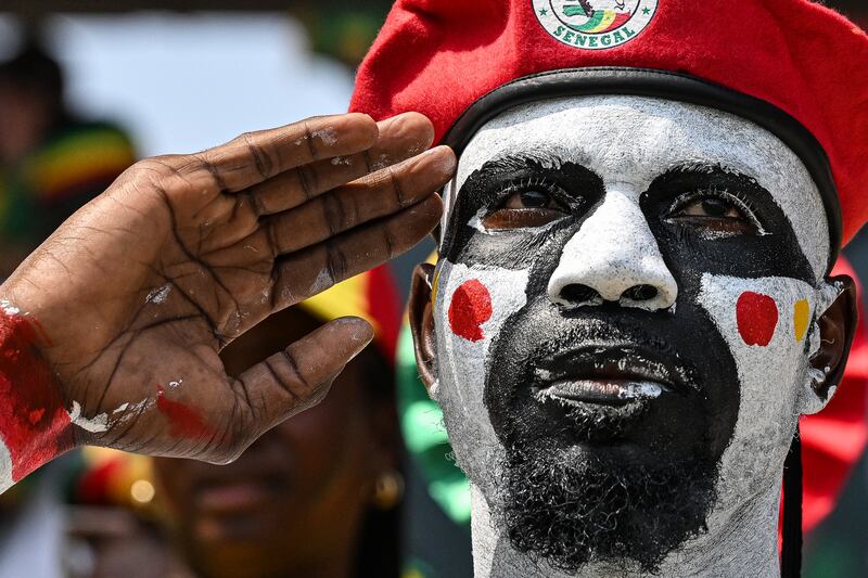 A Senegal supporter in colourful regalia at the game against Gambia. Photograph: Issouf Sanogo/Getty Images
