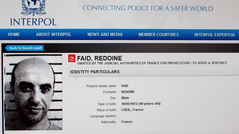 A reproduction of the Interpol website shows the international wanted person notice for French rober Redoine Faid. Image: Interpol/AFP/Getty Images.