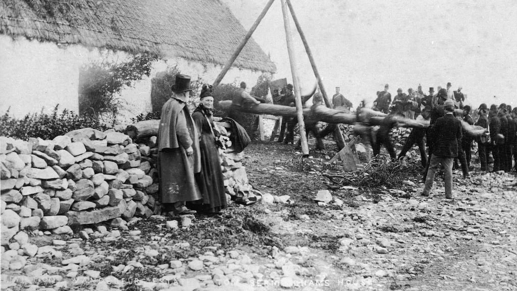A battering ram is used to break into a house on the estate of Captain Hector Vandeleur in Co Clare, during an eviction of tenants for the non-payment of rent in 1888. The tenants have stuffed foliage in the doors and windows to hinder entry. Photograph: Sean Sexton/Getty Images