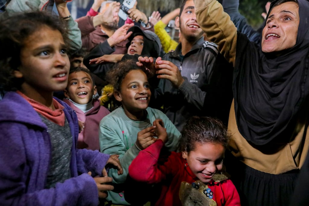 People celebrate along a street at Deir el-Balah in the central Gaza Strip on January 15th as news spreads that a ceasefire and hostage release deal has been reached between Israel and Hamas. Photograph: Youssef Alzanoun/AFP via Getty Images