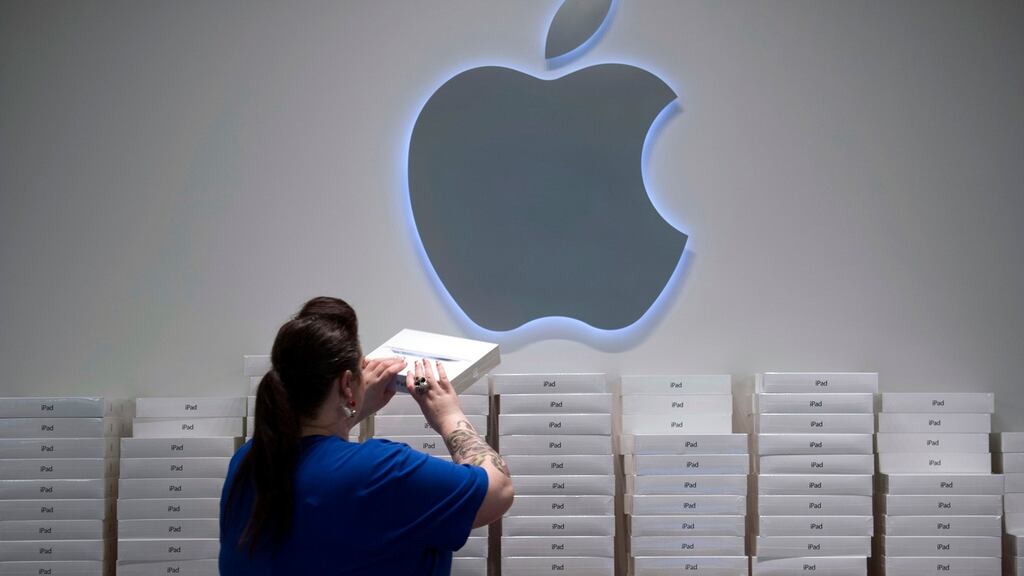 An Apple staffer stacks boxes of the iPad at an Apple store. Photograph: David Paul Morris/Bloomberg
