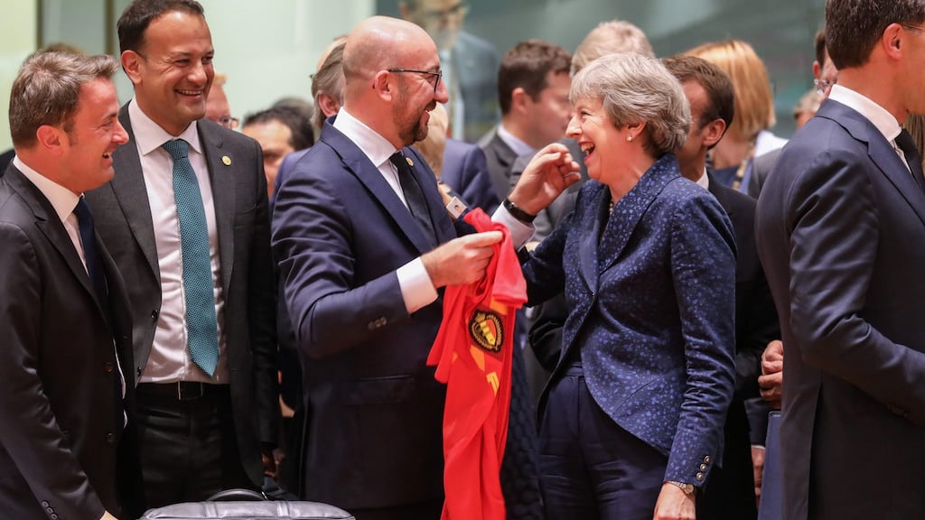 Belgian prime minister Charles Michel and his British counterpart Theresa May exchanging  football jerseys. Photograph: Ludovic Marin/AFP