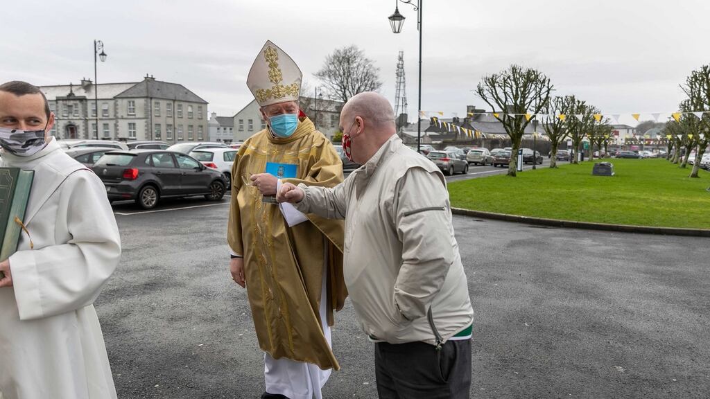 Archbishop-elect Francis Duffy gets an elbow bump from Charles Ward as he waits to enter the Cathedral of the Assumption in Tuam for his Installation Ceremony as Archbishop of Tuam. Photograph: Andy Newman