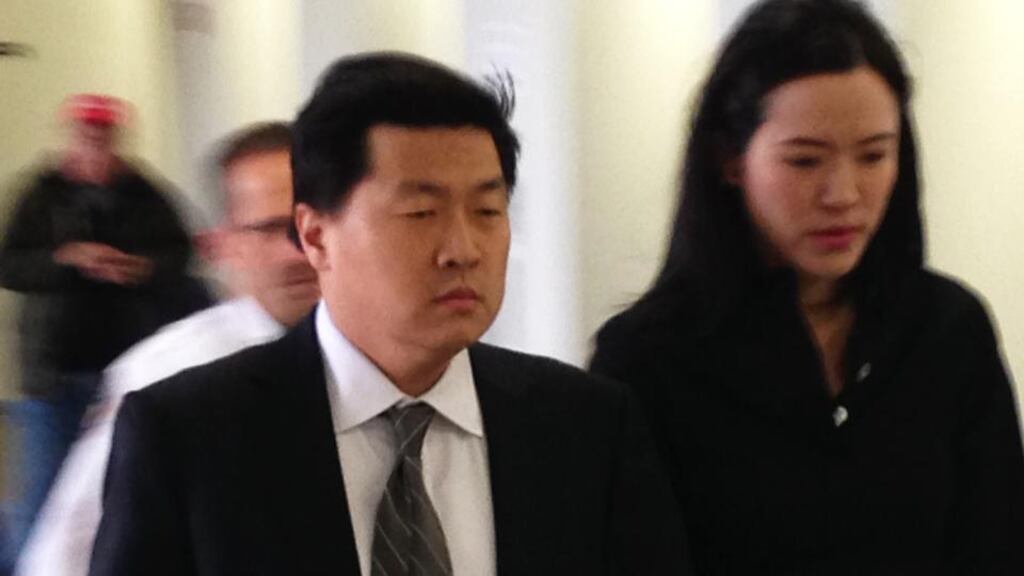 Former New York City investment banker Jason Lee walks with his wife Alicia into Suffolk County Court. Photograph: AP Photo/Frank Eltman