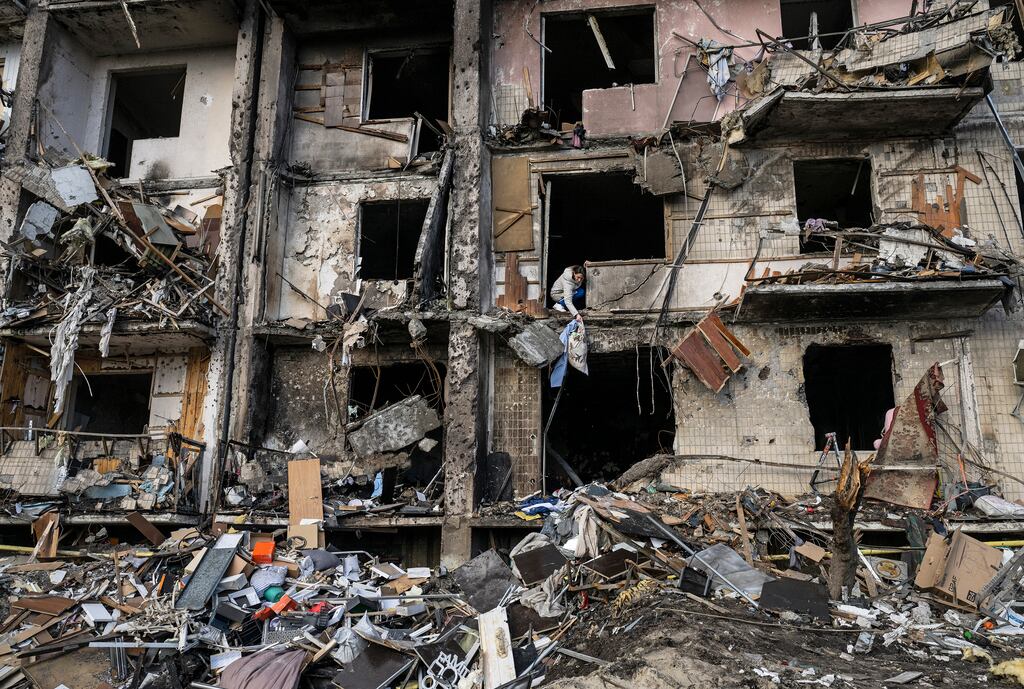People clean up debris after a residential building was hit by missiles in the Ukrainian capital Kyiv earlier this year. Photograph: Lynsey Addario/The New York Times