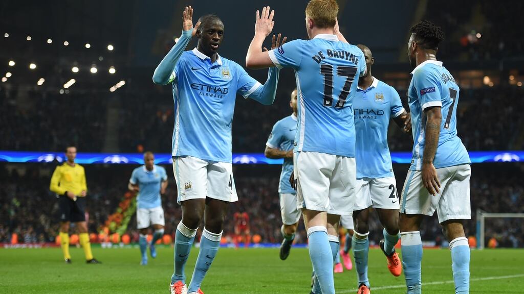 Manchester City’s Belgian midfielder Kevin De Bruyne celebrates with teammates after scoring the winner against Sevilla at the Etihad Stadium. Photograph: Getty Images