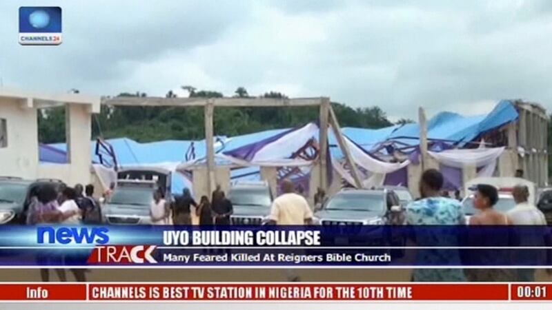 In this image taken from video people stand at the scene after the roof a church collapsed in Uyo, southern Nigeria on Saturday. Photograph: Channels TV via AP
