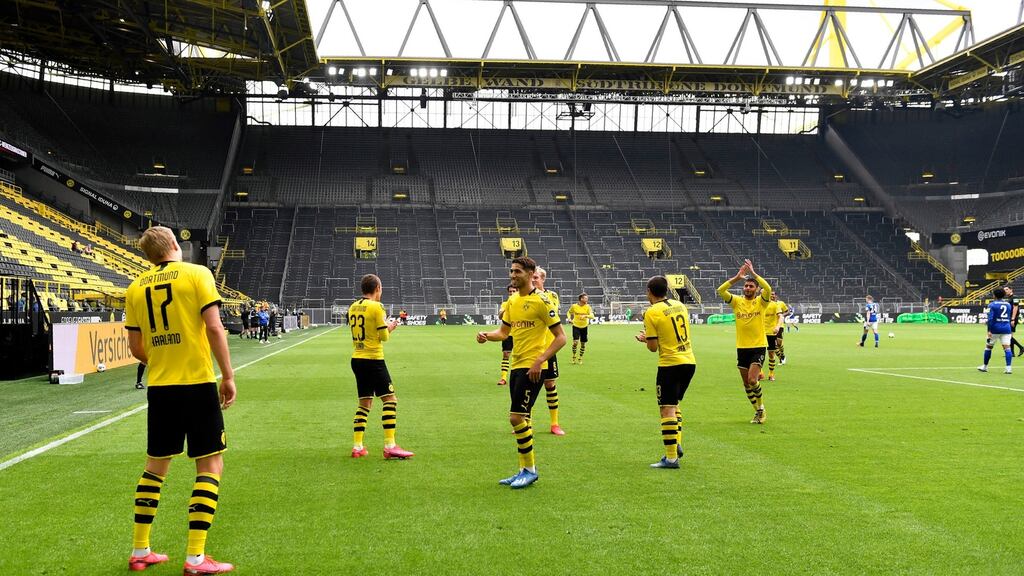 Borussia Dortmund’s Erling Haaland celebrates – at a safe distance from his teammates – after scoring during their Bundesliga win over Schalke. Photo: Martin Meissner/AP Photo