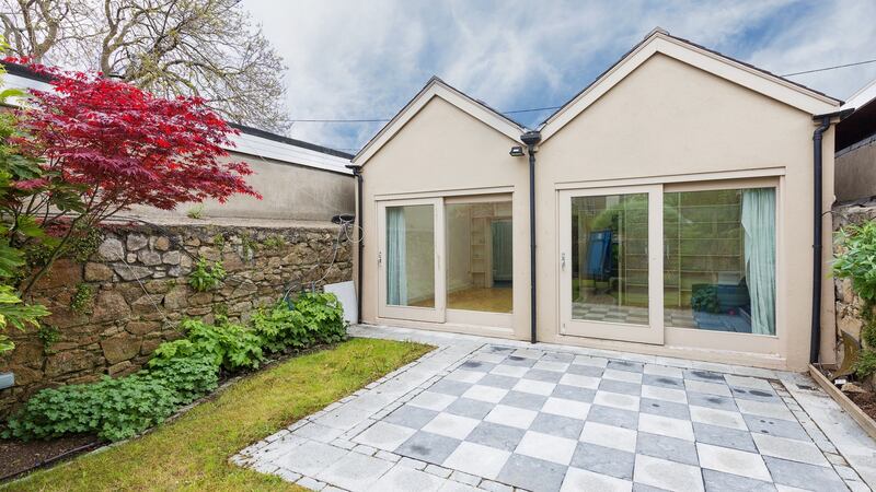 The glazed-fronted garden room is divided into  a room with an ensuite, ideal guest accommodation, and a home gym