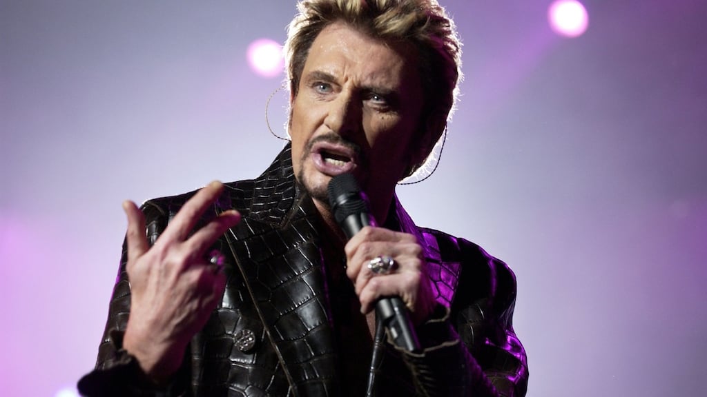 Johnny Hallyday performing on stage in Paris. Hallyday, France’s best-known rock star, has died aged 74 after a battle with lung cancer. Photograph: Bertrand Guay/AFP/Getty Images