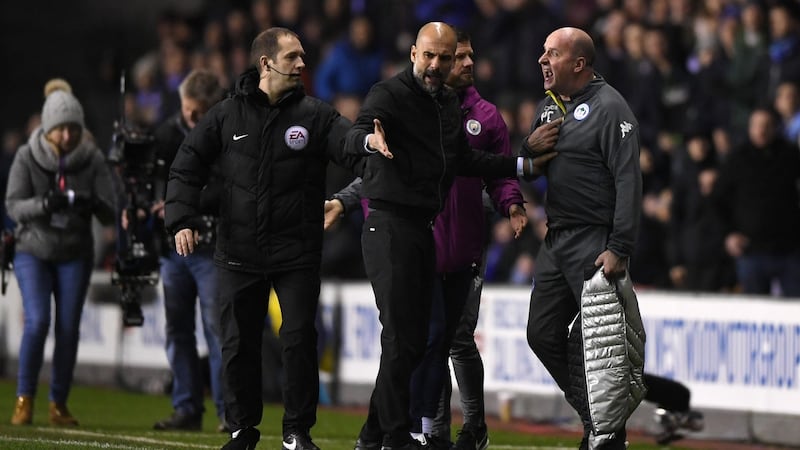 Manchester City manager Pep Guardiola argues with Wigan Athletic manager Paul Cook during the FA Cup fifth-round match at DW Stadium Photograph: Gareth Copley/Getty Images