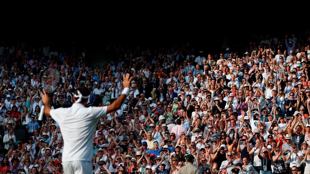 Roger Federer celebrates beating Kei Nishikori during their men’s singles quarter-final match at Wimbledon. Photo: Adrian Dennis/Getty Images