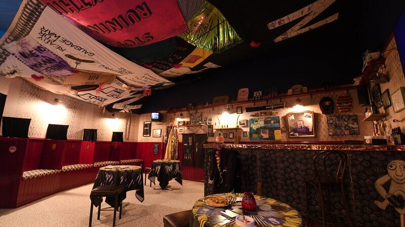 The sibin, a ‘pub without permission’, is an immersive installation with a large canopy styled from banners which provides a floating roof and a circle of flag poles that reference ancient Irish ceremonial sites. Photograph: Doug Peters/PA Wire