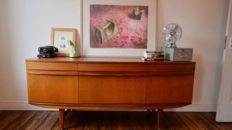 A teak sideboard displaying drawings by Art Spiegelman for Maus in the home of design historian Linda King in North Strand, bought when she lived in New York, and a mint green Ericsson Ericofon bought in Turin. Photograph: Alan Betson