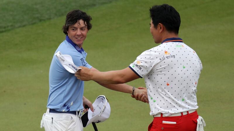 A young Rory McIlroy is congratulated on his sensational eight-stroke victory in the 2011 US Open by Y.E. Yang at Congressional Country Club in Bethesda, Maryland. Photo by Ross Kinnaird/Getty Images)