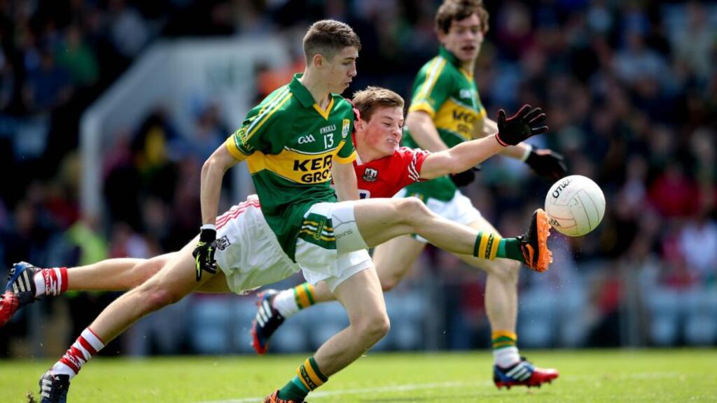Kerry’s Jordan Kiely scores a goal despite the efforts of Tom Bushe of Cork during their Munster minor football final at Páirc Uí Chaoimh, Cork. Photograph: Inpho
