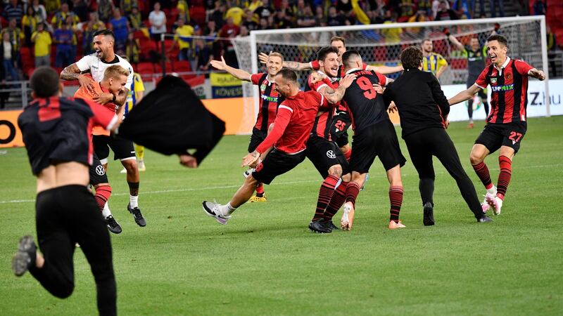 Budapest Honved players celebrate at the final whistle. Photo: Zsolt Szigetvary/EPA