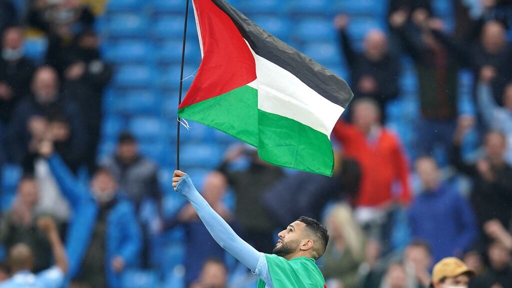 Manchester City’s Riyad Mahrez with a Palestine flag after winning the Premier League trophy - a stadium named after him was to be opened in his home town even before his more recent exploits for City and inspiring Algeria to victory in the Africa Cup of Nations in 2019. Photograph: PA