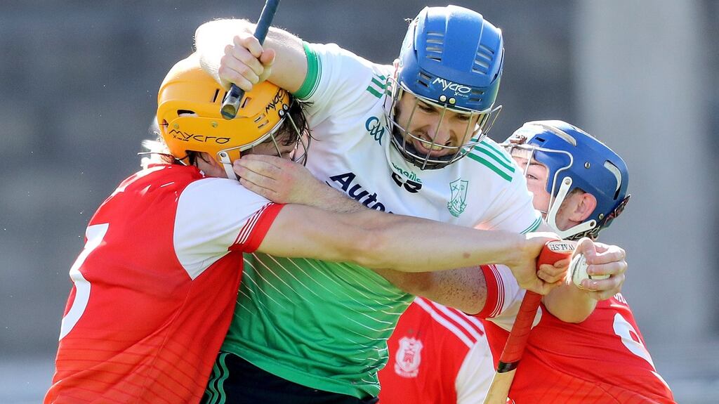 Lucan Sarsfields’ Emmett Ó Conghaile is tackled by Cian O’Callaghan and Sean Treacy of Cuala during the Dublin SHC semi-final at Parnell Park. Photograph: Bryan Keane/Inpho