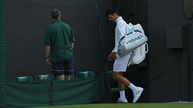 Djokovic leaves the court after retiring in his loss to Berdych. Photo: Glyn Kirk/Getty Images