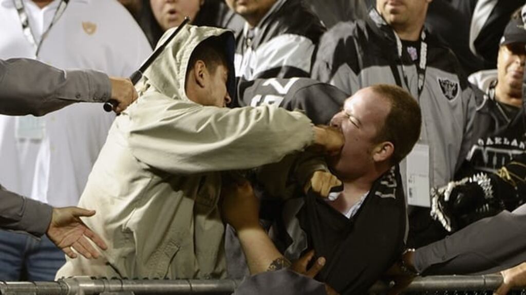 Two fans fight during a Chargers and Raiders game at Oakland-Alameda County Coliseum. Photograph: Thearon W. Henderson/Getty Images