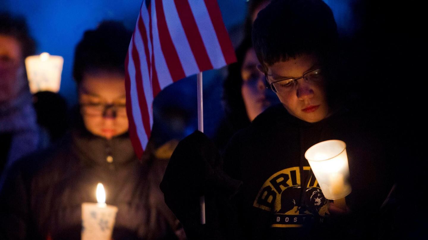 People hold candles during a vigil for slain MIT police officer Sean Collier at the Town Common in Wilmington, Massachusetts. Mr Collier, was shot multiple times in his car on Thursday night as Boston Marathon bombing suspects Dzhokhar Tsarnaev and his brother Tamerlan tried to evade capture. Photograph: Dominick Reuter/Reuters